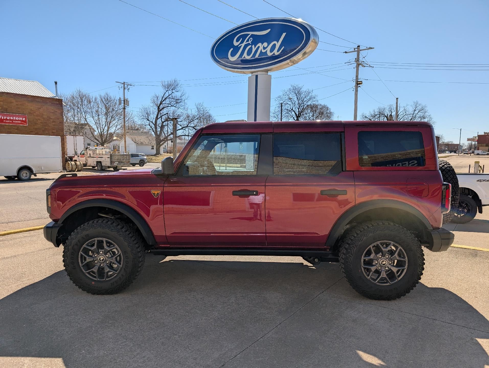 2025 Ford Bronco Badlands 4 Door Advanced 4x4 in Ruby Red Metallic Tinted Clearcoat — front three-quarter view