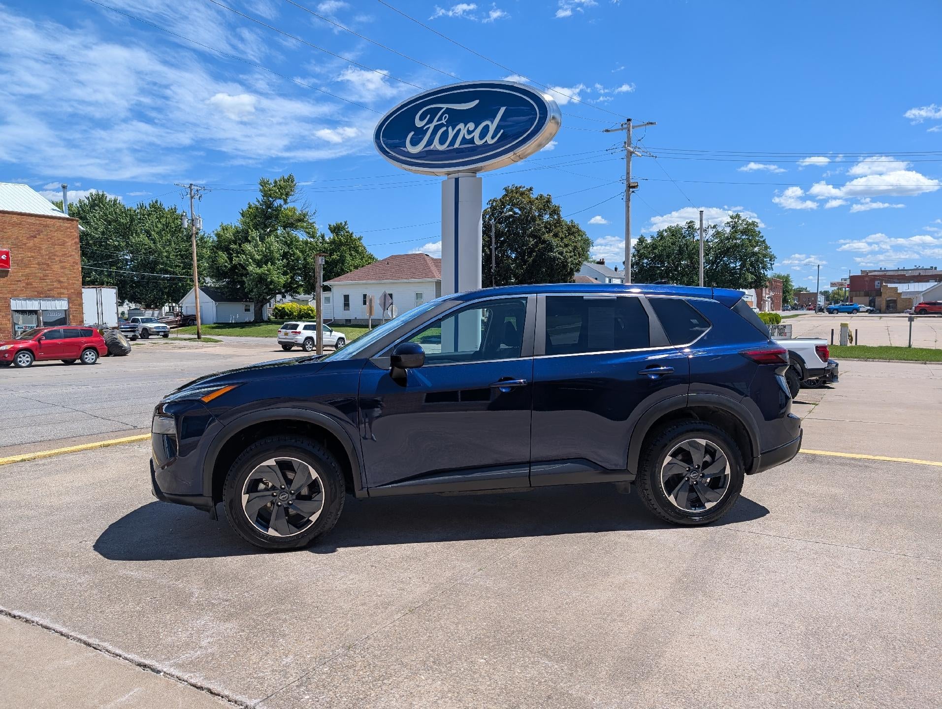 2025 Nissan Rogue AWD SV in Deep Ocean Blue Pearl — front three-quarter view